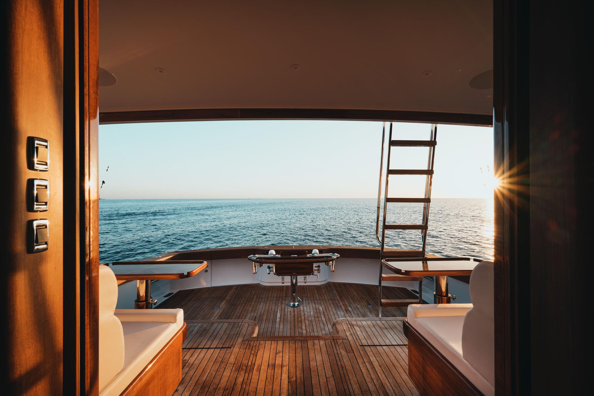 Luxurious yacht deck with wooden floor and ocean view at sunset