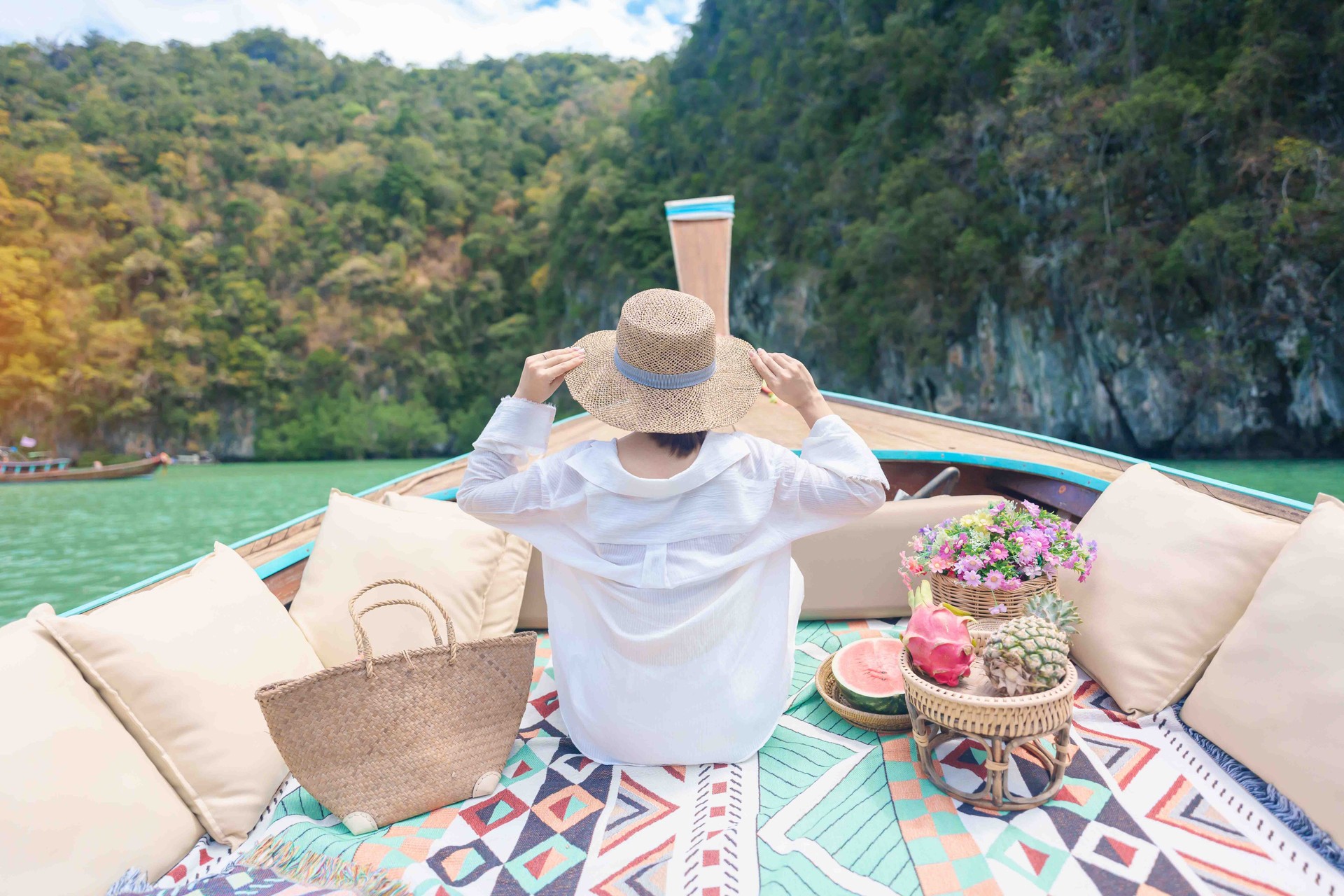 Happy Woman tourist in private longtail boat trip to koh Hong lagoon island at Krabi, Thailand. landmark, tropical destination, southeast Asia Travel, summer vacation, wanderlust and holiday concept